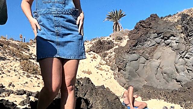 Girl is fingering pussy in front of stranger on the public beach