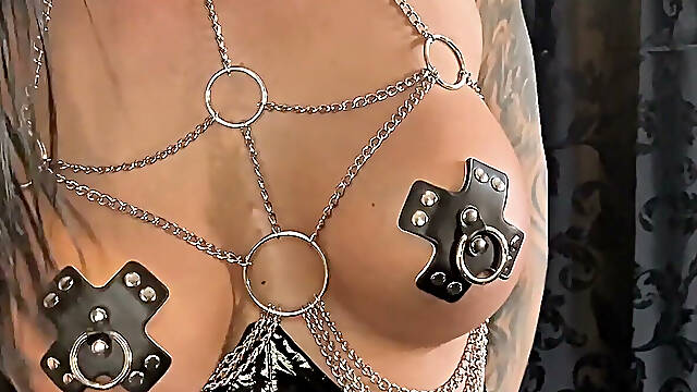 Lady Medusa in a Leather Chain Harness Demonstrates the New Instruments